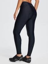 Black women's padded cycling tights with reflective dots, utility pockets, and cycling shoes. #color_Black