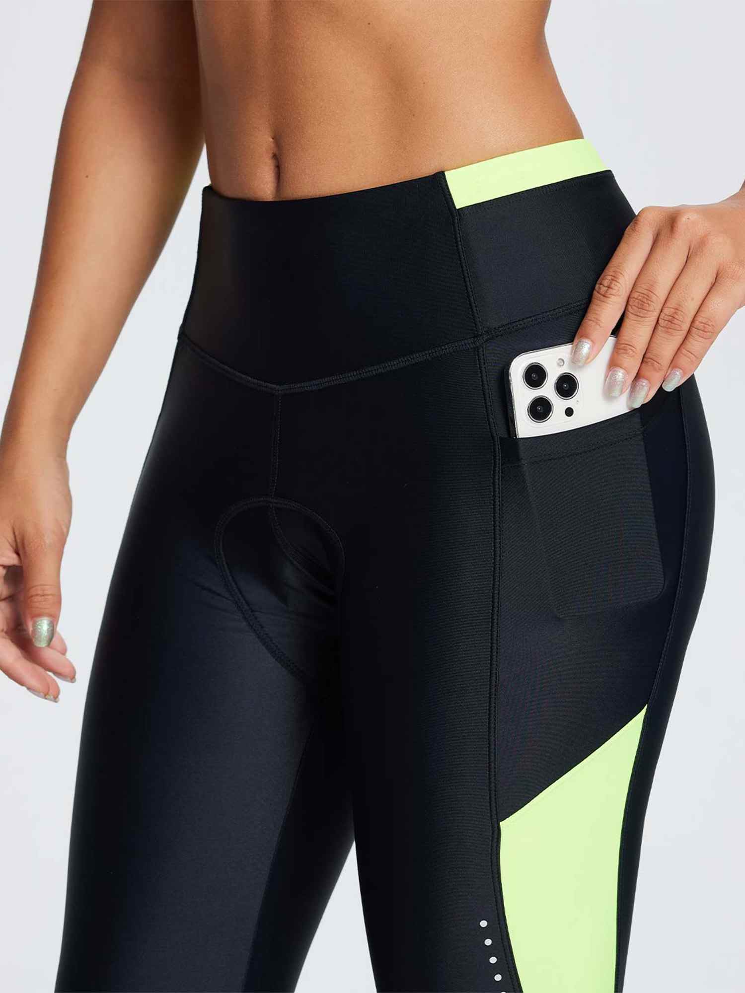 Women's black padded cycling tights with vibrant yellow colorblock panels and thigh phone pocket. #color_Fluorescent Green