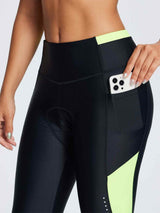 Women's black padded cycling tights with vibrant yellow colorblock panels and thigh phone pocket. #color_Fluorescent Green