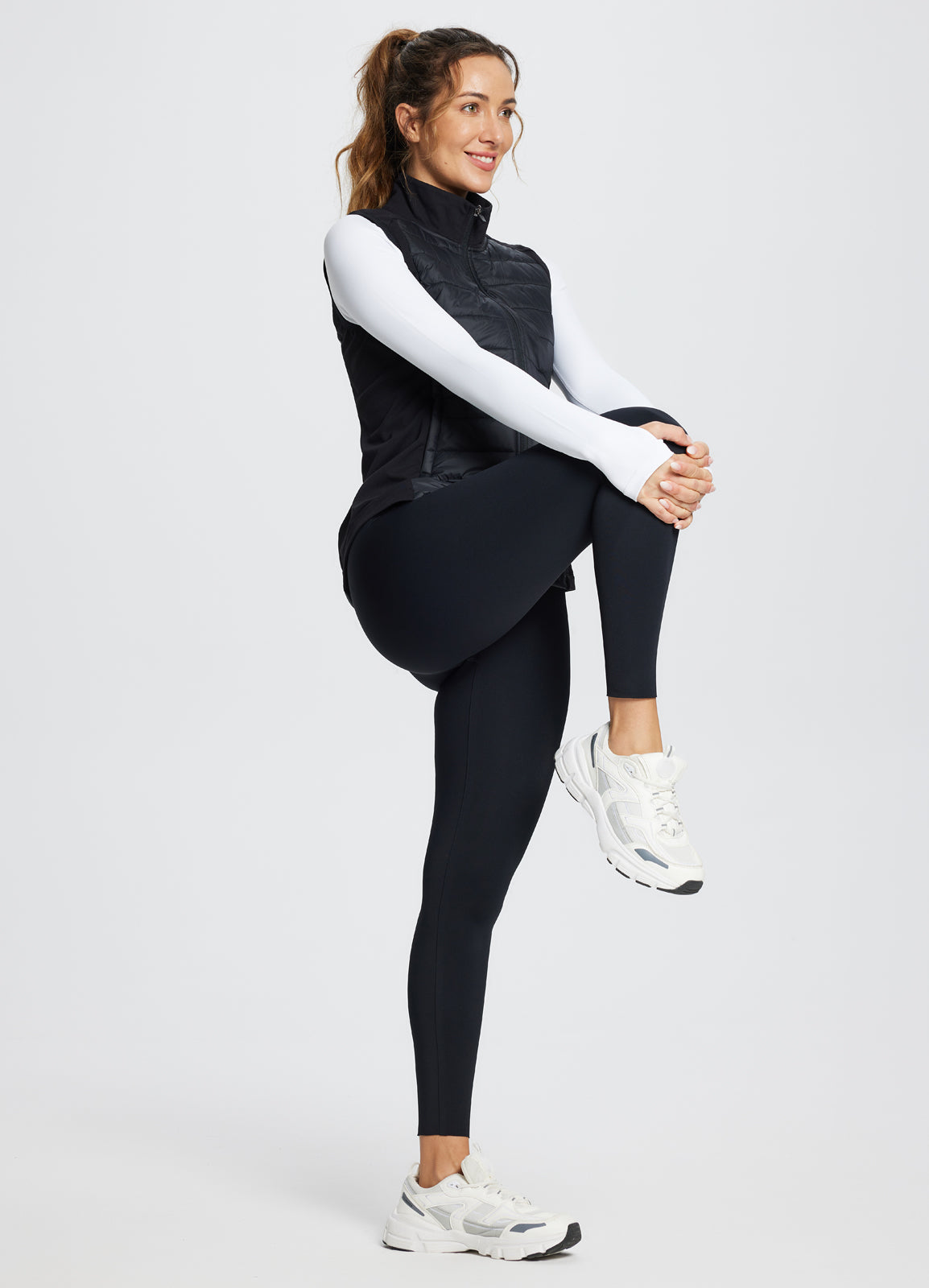 Running slim-fit puffer vest for women, black, active lifestyle model