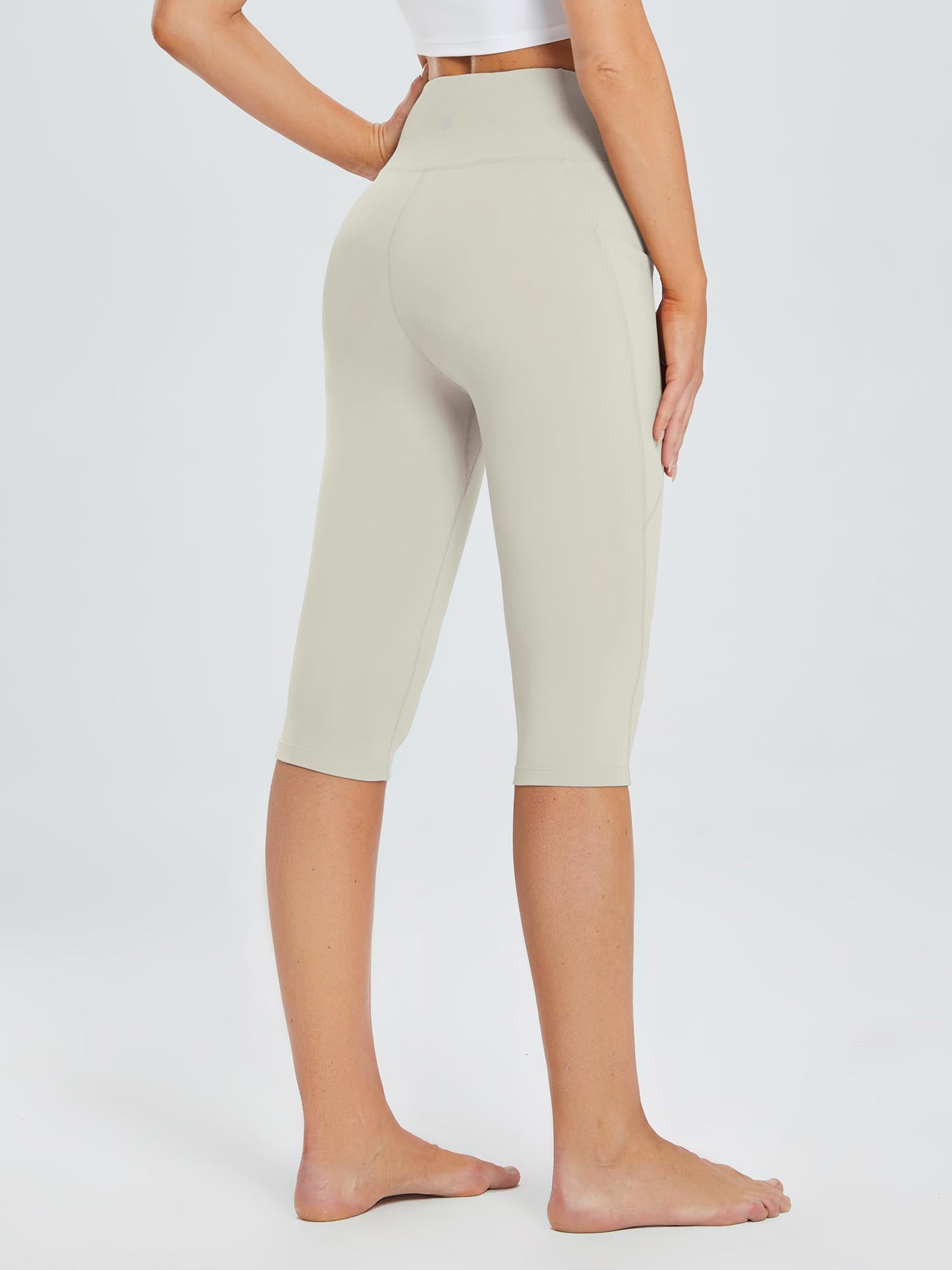 Laureate women's cream high-waisted pocketed yoga capris with 4-way stretch fabric. #color_Light Brown