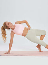 Laureate women's light grey pocketed yoga capris, high-waisted, on woman in yoga pose. #color_Light Brown
