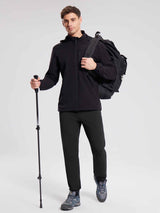 Men's black reflective fleece joggers for hiking, with backpack and pole. #color_Black
