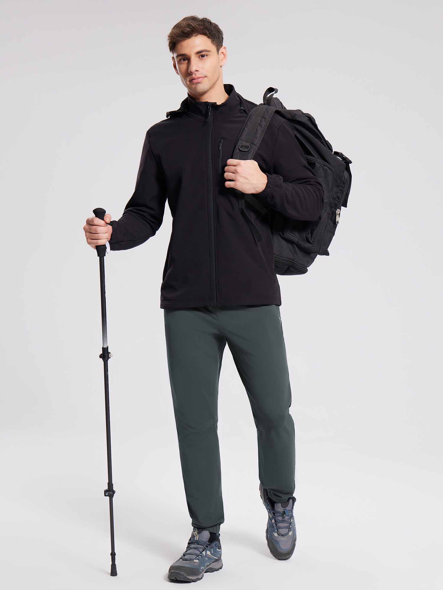 Men's reflective fleece jogger pants shown on model with outdoor gear and trekking pole. #color_Dark Gray