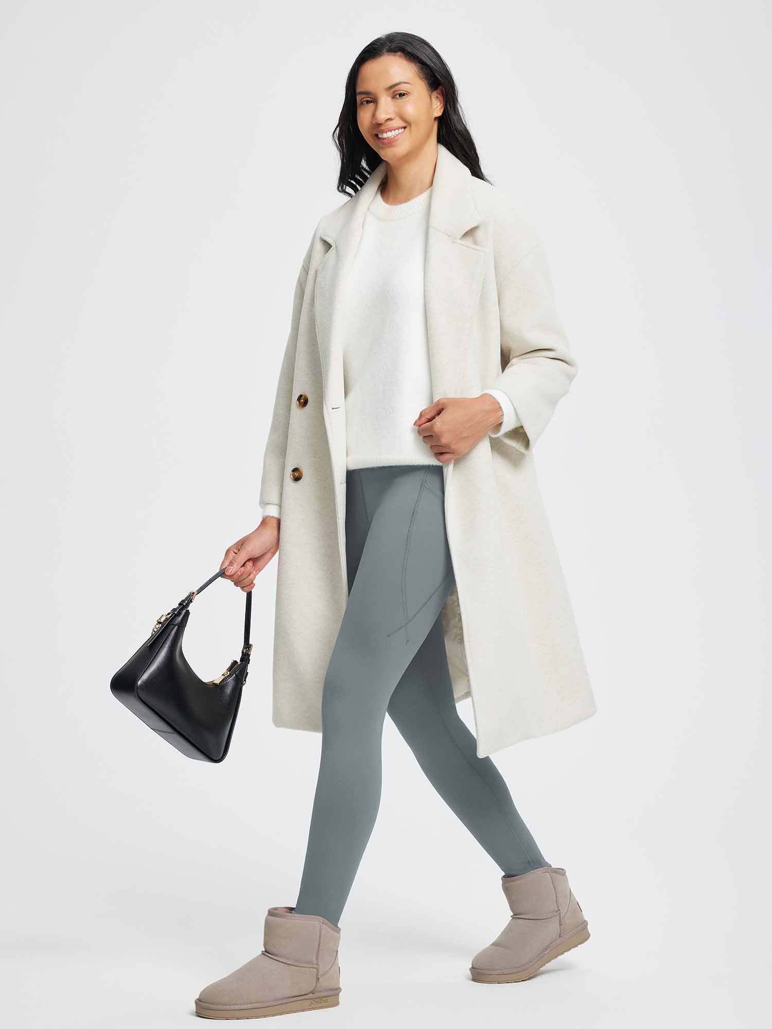 Grey thermal fleece high-waist yoga leggings worn with a winter coat and boots. #color_Dark Gray