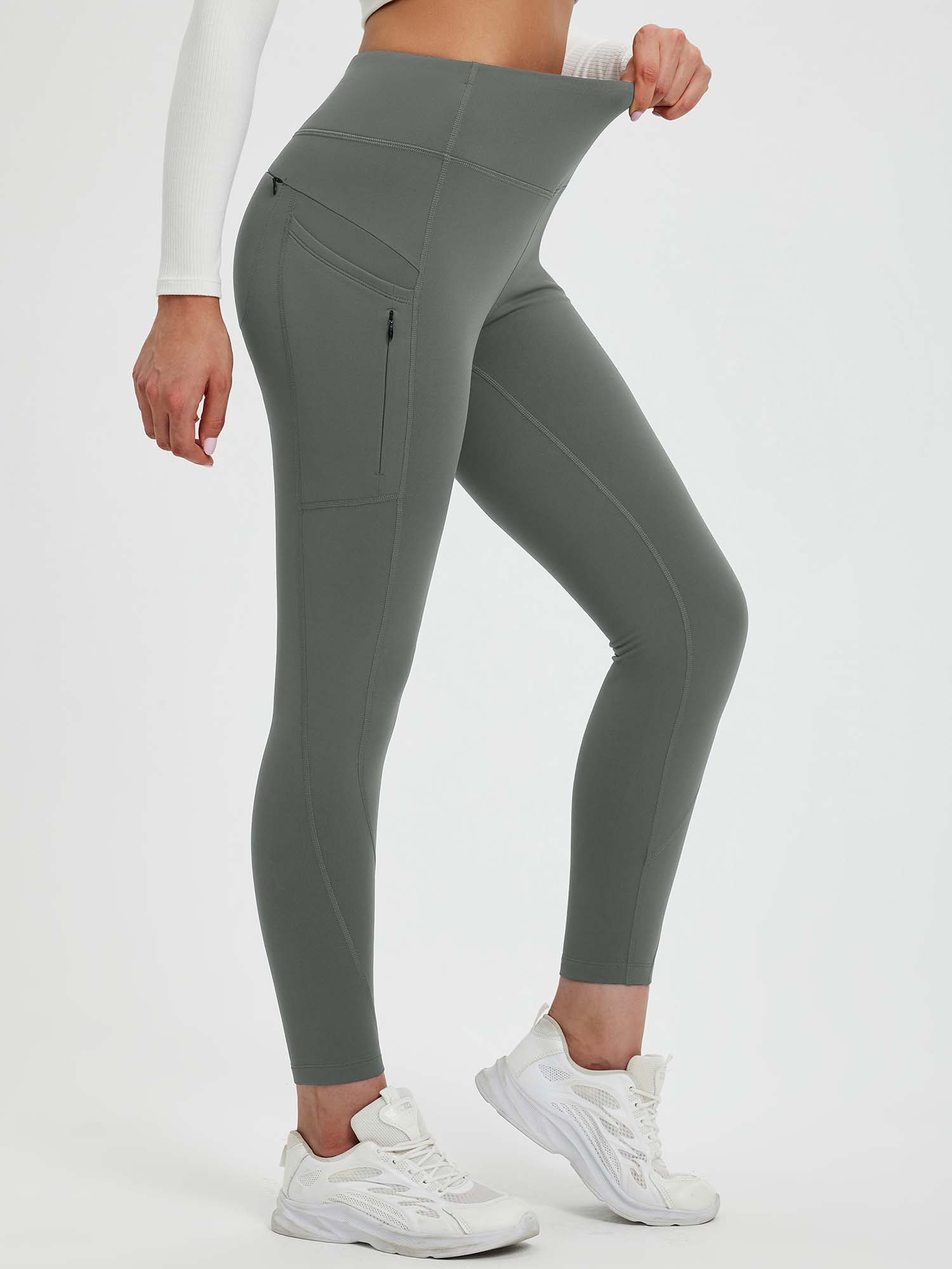 Grey 25" fleece-lined yoga leggings featuring a high waistband and secure zippered side pockets. #color_Dark Gray