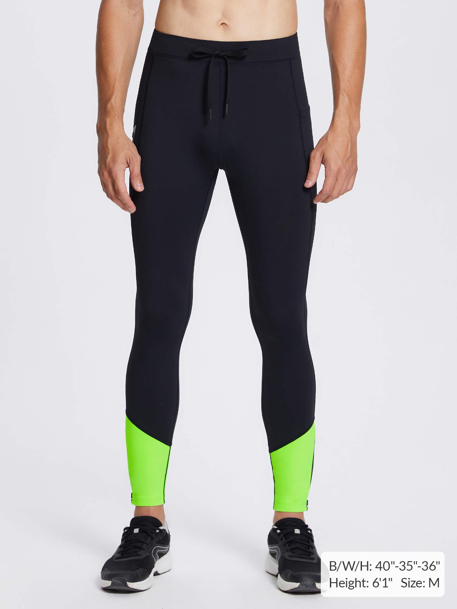 Men's black fleece lined running tights with lime green ankle panels.