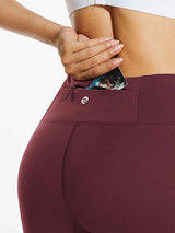Burgundy fleece-lined running leggings with water-resistant zippered pocket. #color_Wine Red
