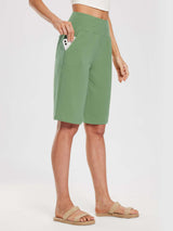 Woman wearing light green 12" cotton Bermuda shorts with a phone in the pocket. #color_Green