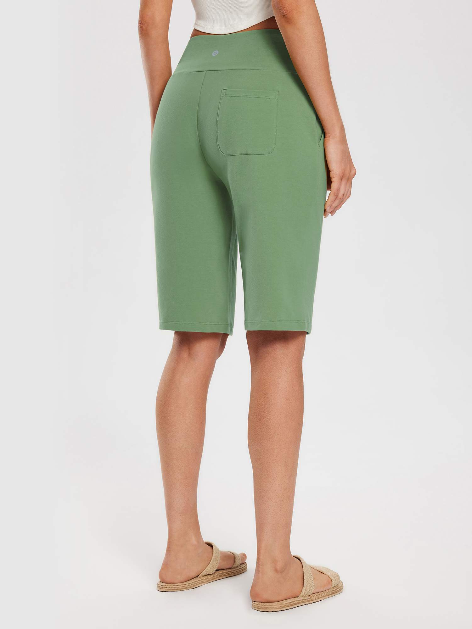 Woman wearing light green 12" inseam cotton Bermuda shorts with a high waistband and a back pocket. #color_Green