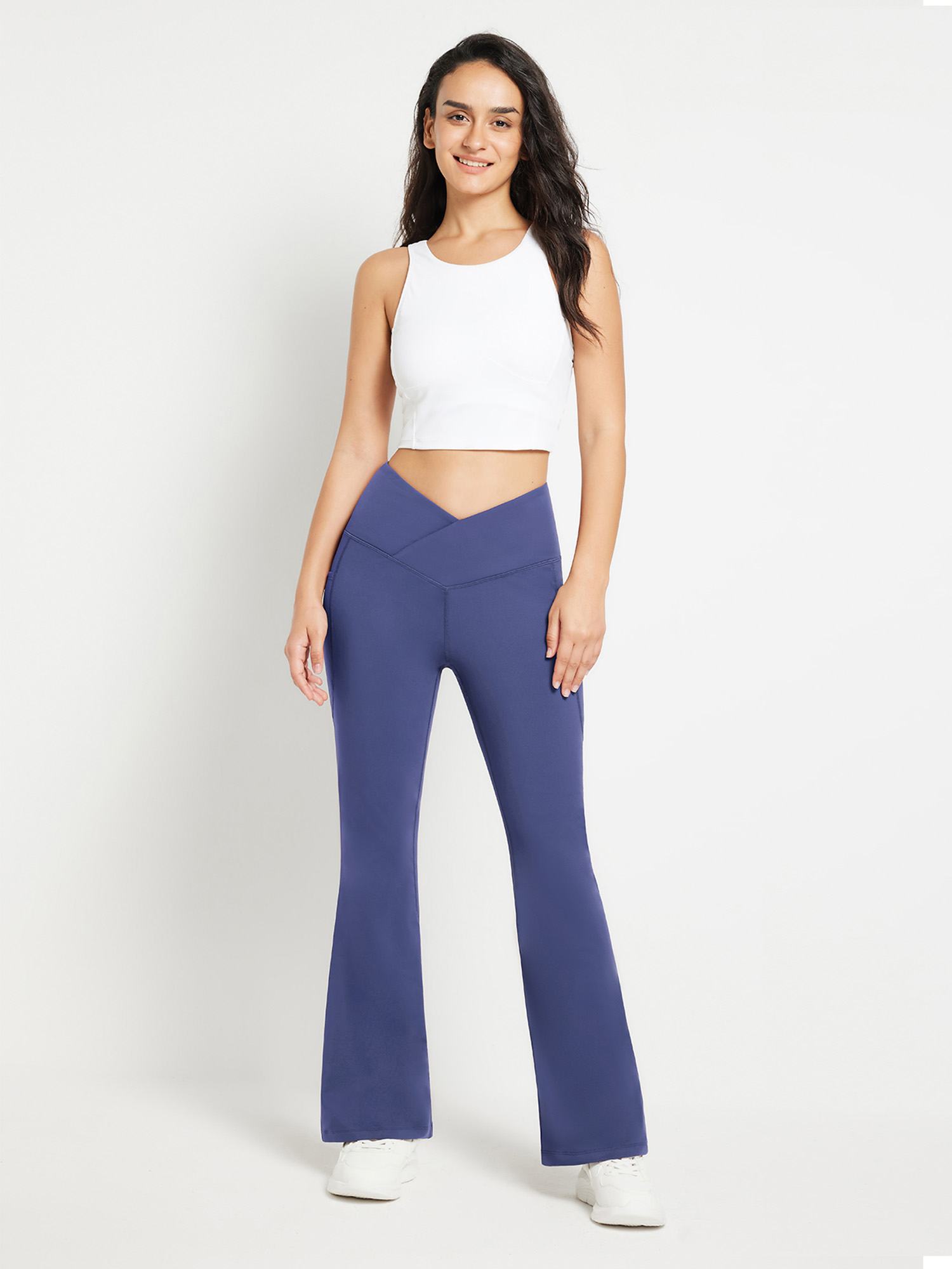 Blue crossover waist fleece-lined flare pants with high-rise design.