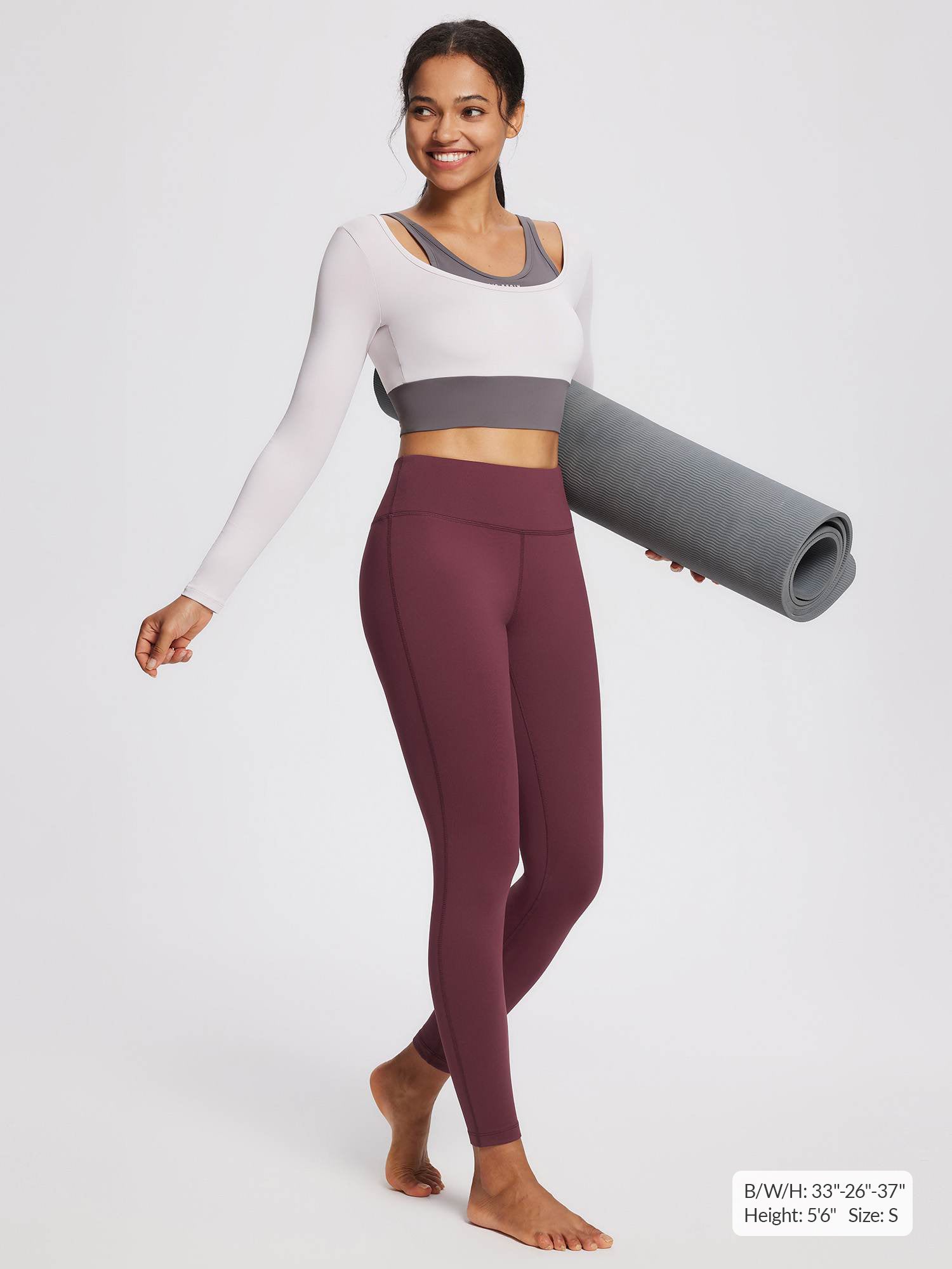 Women's petite burgundy fleece-lined yoga leggings with high waistband, model holding yoga mat.