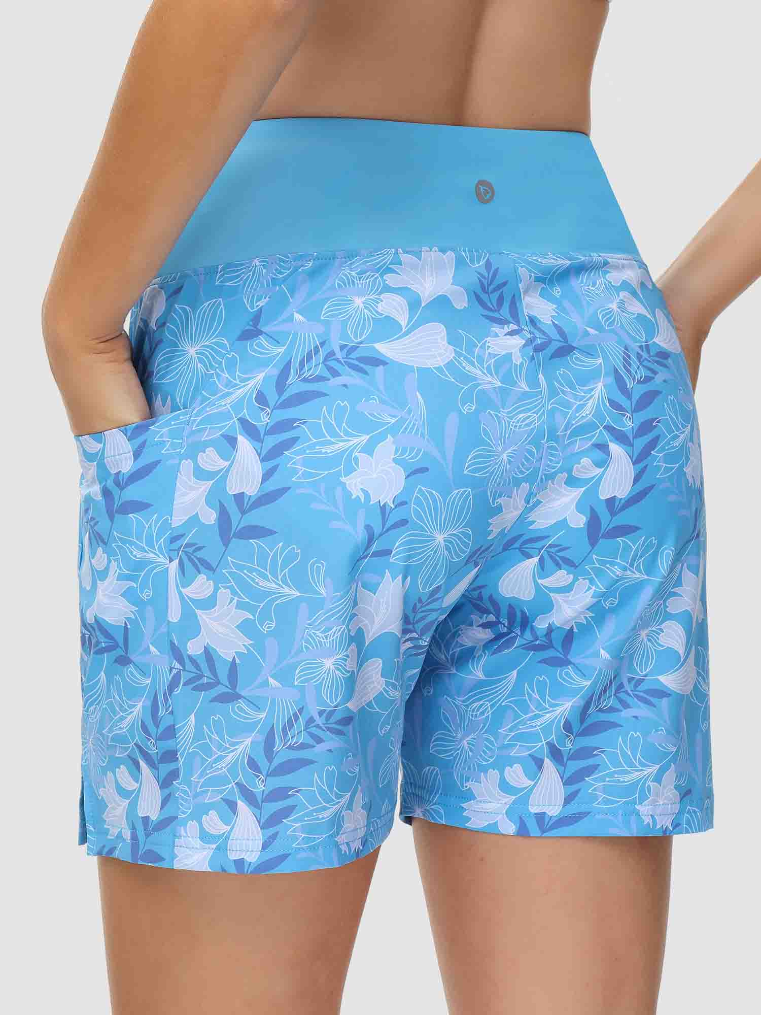 Women's blue 5-inch board shorts with white floral print, high waist, and pockets. #color_Print 3