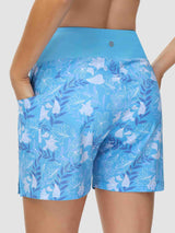 Women's blue 5-inch board shorts with white floral print, high waist, and pockets. #color_Print 3