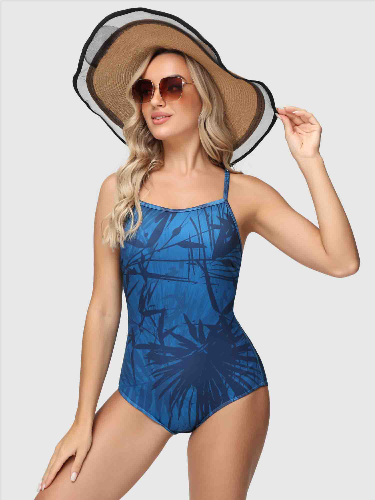 Women's printed one-piece swimsuit in blue with navy tropical leaf design. #color_Blue
