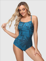 Women's blue one-piece swimsuit with a bold tropical leaf print.