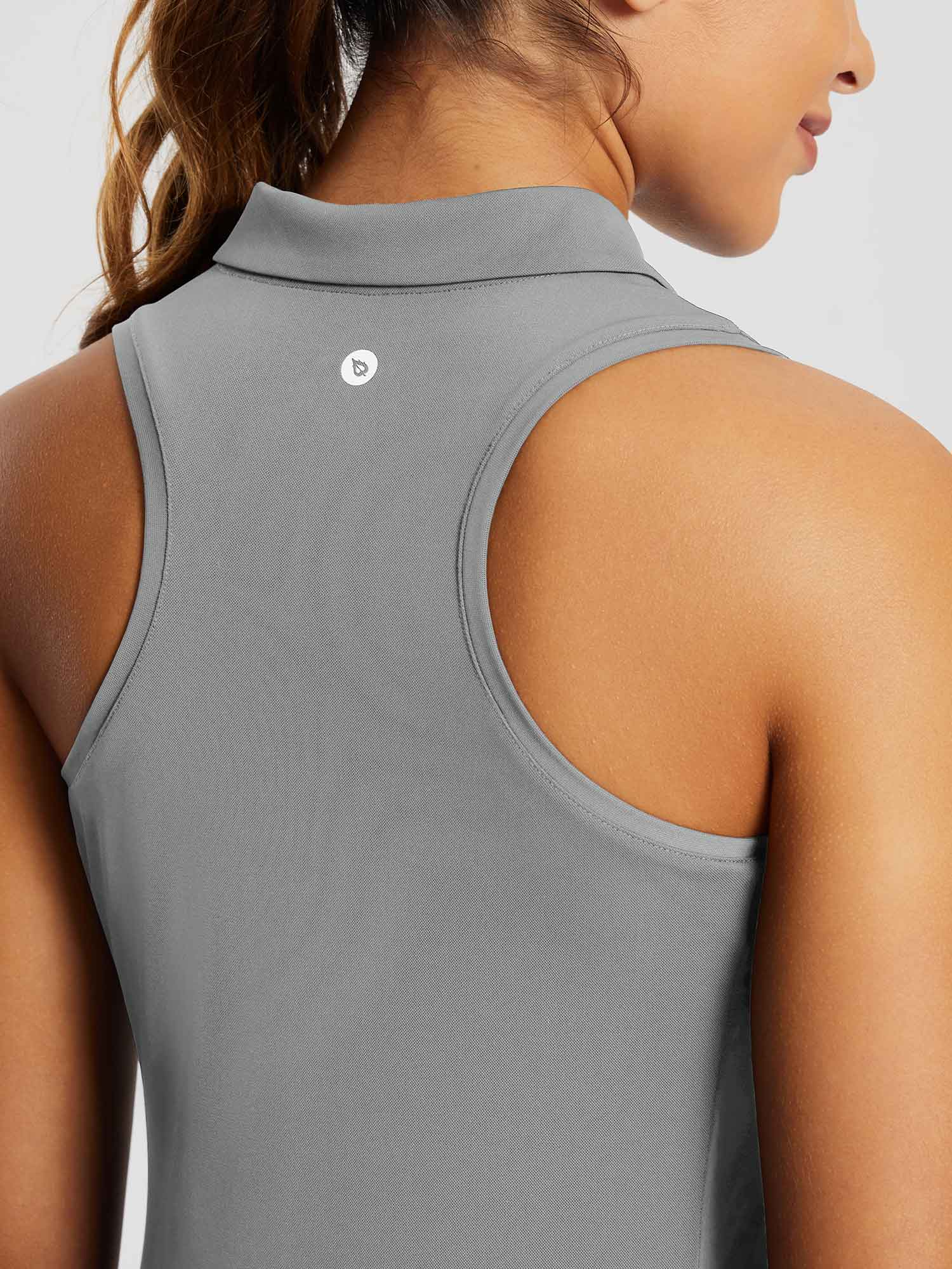 Light grey women's sleeveless golf polo shirt with racerback design and logo. #color_Light Gray