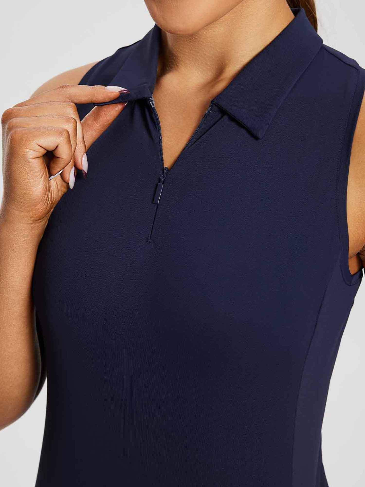 Navy women's sleeveless golf polo shirt featuring a 1/4 zipper collar. #color_Navy Blue