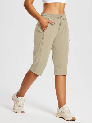 Woman wearing beige DWR pocketed capri pants for everyday outdoor comfort and hiking. #color_Doeskin