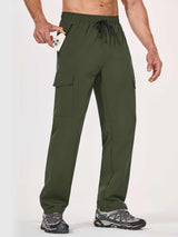 Man in olive green UPF 50+ quick-dry hiking cargo pants putting a smartphone in a zippered pocket. #color_Army Green