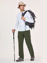 Man in olive green UPF 50+ quick-dry hiking cargo pants with backpack and hiking stick. #color_Army Green