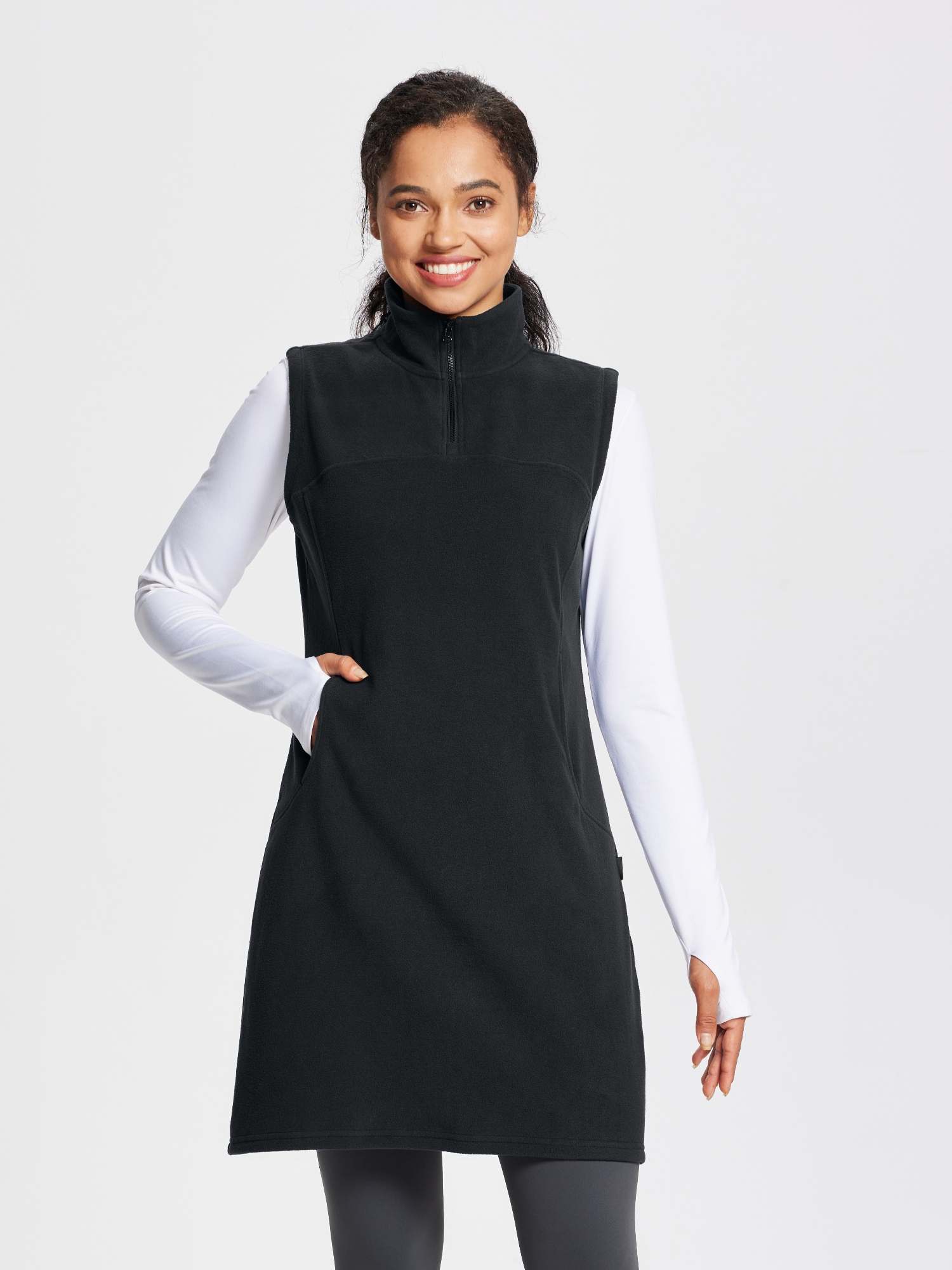 Black sleeveless fleece thermal dress with quarter-zip and pockets, perfect for outdoor activities. #color_Black