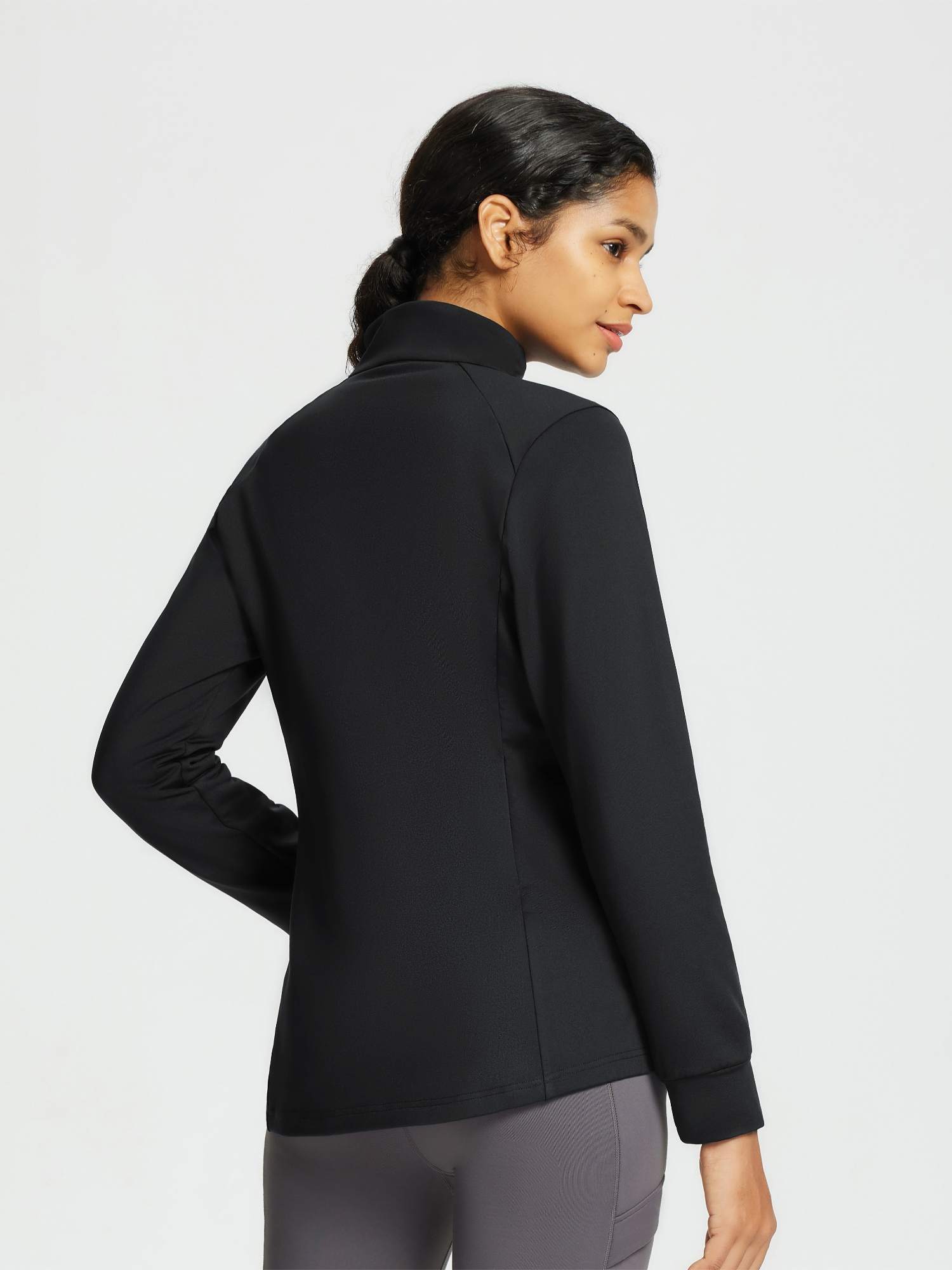 Black women's outdoor jacket with quilted texture and stand collar.