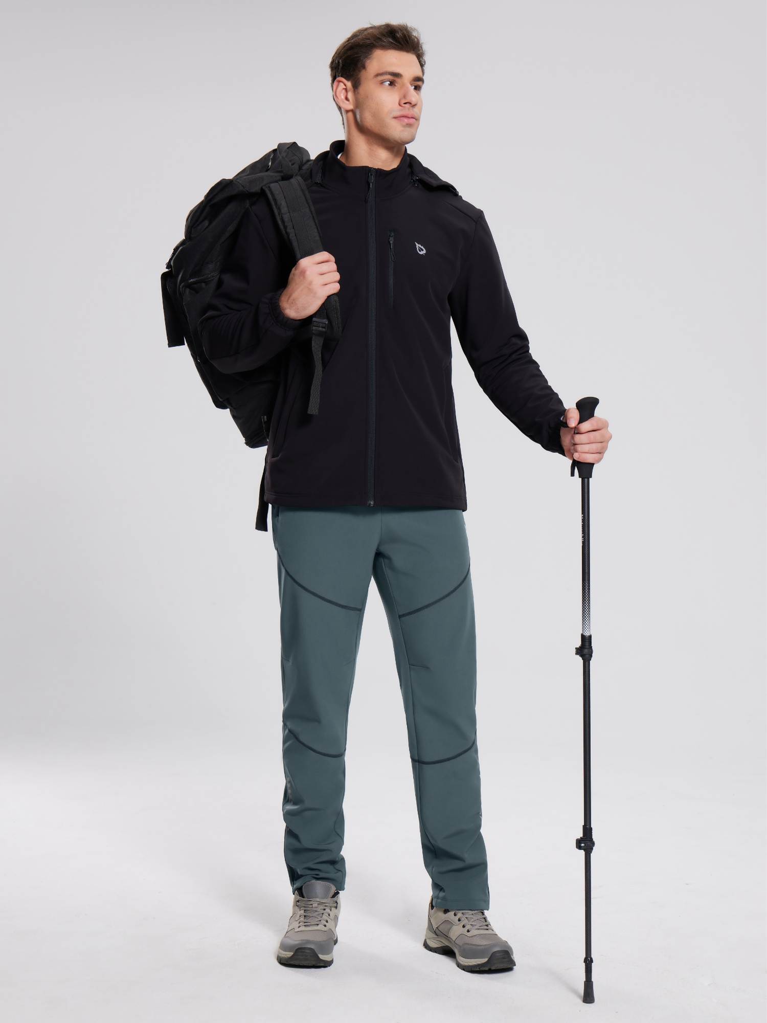 Man in grey-green elastic waist fleece mountain pants with stitched legs, black jacket. #color_Dark Gray