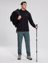 Man in grey-green elastic waist fleece mountain pants with stitched legs, black jacket. #color_Dark Gray
