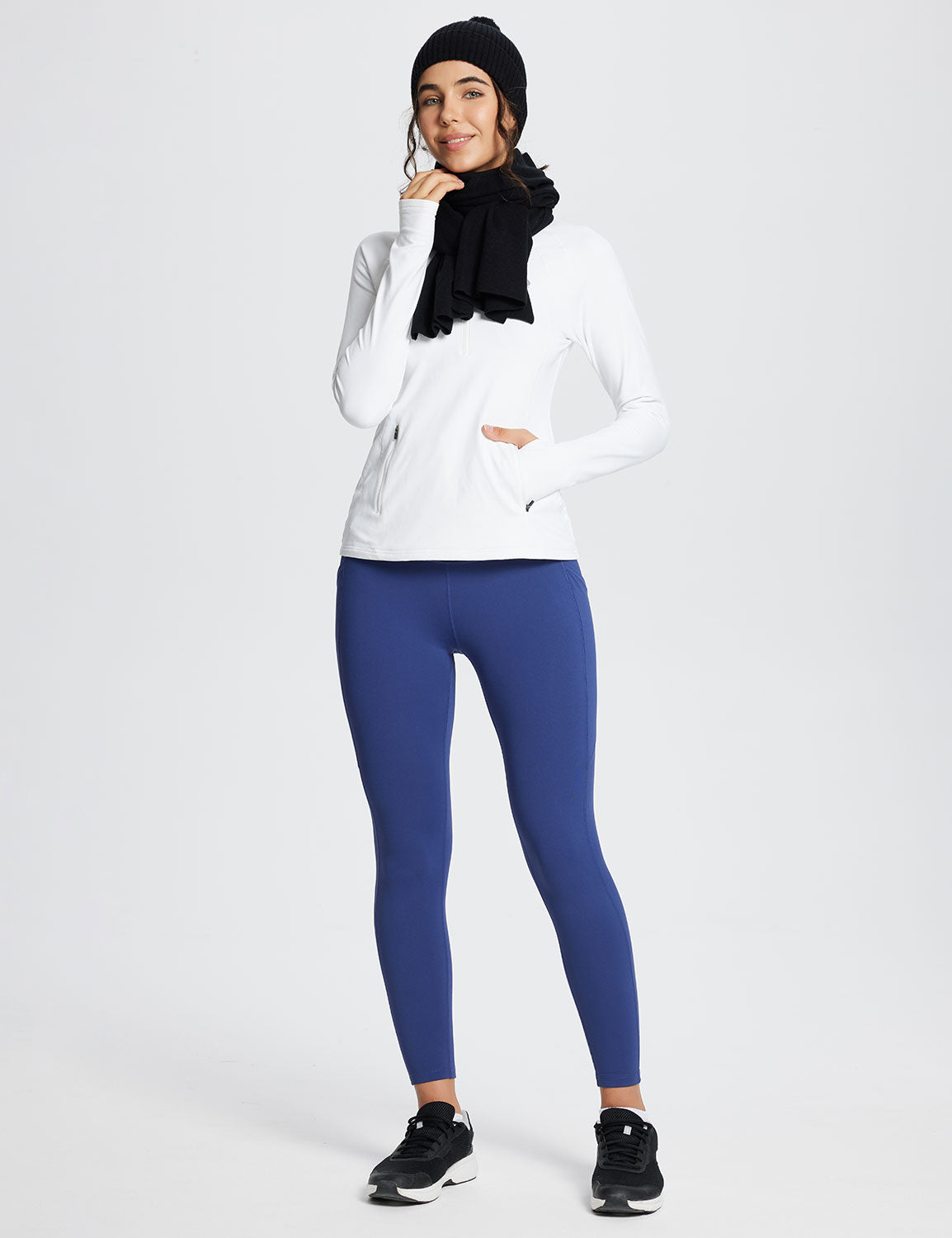 Woman wearing Laureate High-Rise Thermal Leggings in blue, white long-sleeve top, and black beanie.