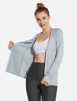 Light gray Laureate UPF 50+ cooling zip-up jacket on woman with white sports bra and dark gray leggings. Features thumbholes.
