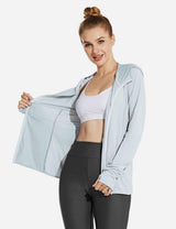 Light blue Laureate UPF 50+ cooling zip-up jacket on woman. Features thumbholes, open front over white sports bra and dark leggings.