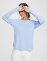 Light blue UPF 50+ long sleeve shirt with crew neck and thumbholes on a woman wearing white pants. #color_Kentucky Blue