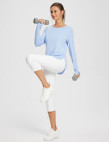 Woman in light blue UPF 50+ long sleeve shirt & white capris, one-legged squat, holding dumbbells. #color_Kentucky Blue