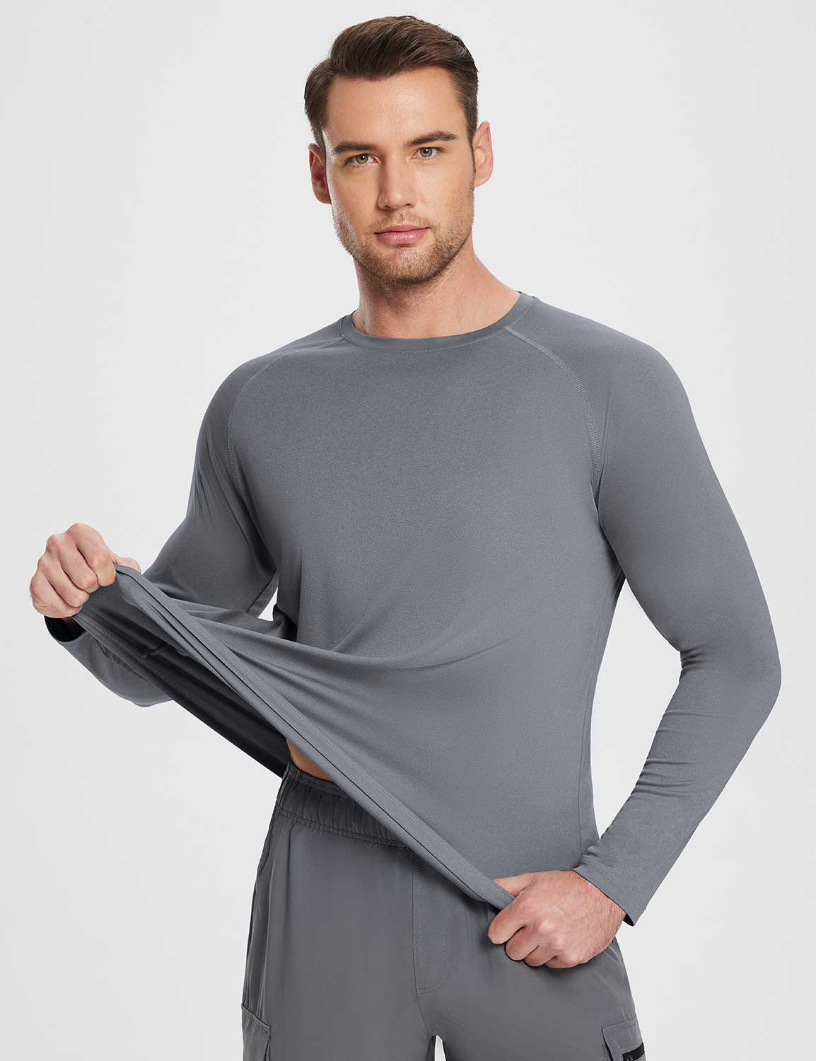 Flyleaf Men's UPF 50+ grey crew neck long-sleeve sun shirt showing fabric stretch and softness.