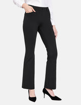 Woman wearing black Workleisure Bootcut Pants with a white blouse and black heels.